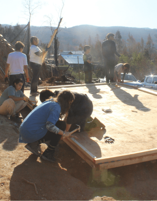Estudiantes de la UC construyendo la base de una casa en Santa Juana